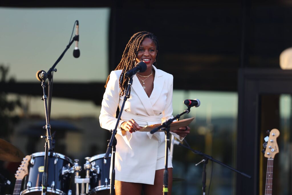 Musician in front of mic and drums in background