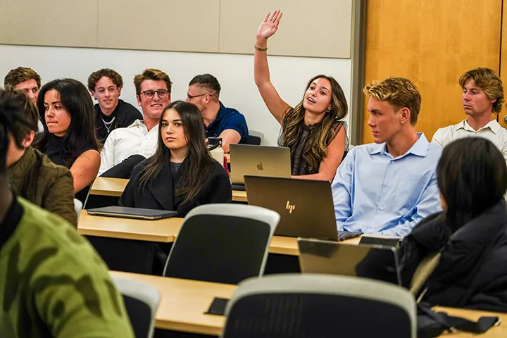 students attending an event with one girl raising her hand