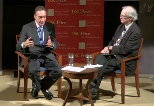 2 people sitting on chair and talking